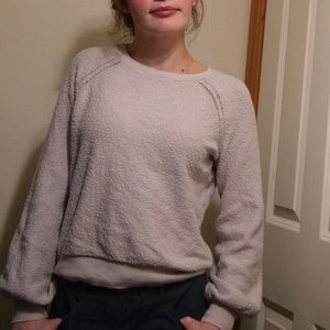 White sweater with a pinkish tint